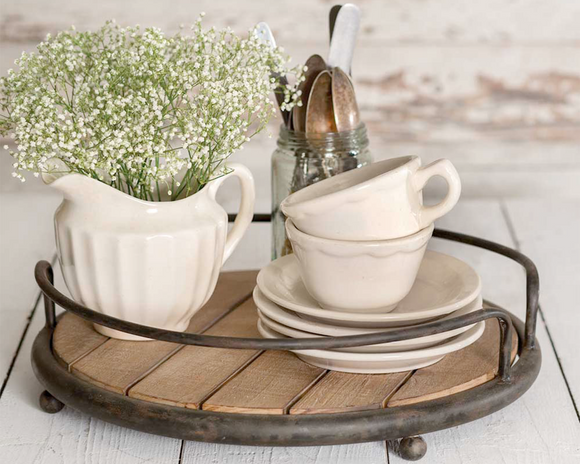 Rustic farmhouse round wood plank serving tray

Add rustic style to a dining room server or bathroom counter with this lovely tray. It features a plank wood base and metal accents. Its size makes it perfect for carrying small dishes. This tray is a great choice as a housewarming gift.

Materials:
Wood, metal

Dimensions:
4
