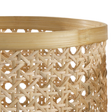 Close-up of a woven basket with a geometric pattern on a white background