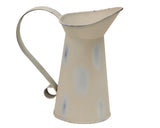Elevate your counters or mantel with this 6-inch distressed ivory metal pitcher vase. Features a classic strap handle for an authentic, time-worn farmhouse look. Perfect for faux greenery and cotton stems.