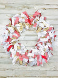 Close-up of the rustic raw-cut edges, textured burlap strips, and grosgrain ribbons on the handmade red country style garland.