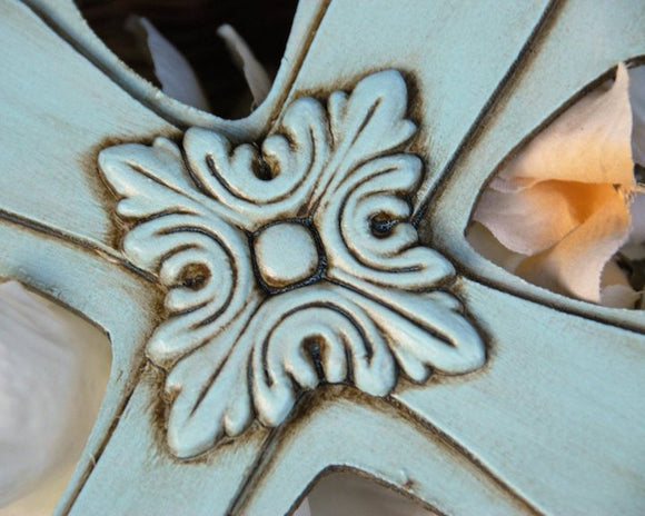 A robin's egg blue embellished wooden wall cross with a floral design, suited for home and nursery decor.