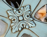 A robin's egg blue embellished wooden wall cross with a floral design, suited for home and nursery decor.